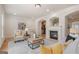 Cozy living room featuring a fireplace, comfortable seating, and open access to other rooms at 10775 Brunson Dr, Johns Creek, GA 30097
