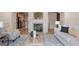 Open living room showcasing a fireplace, comfortable seating, and seamlessly connected kitchen at 10775 Brunson Dr, Johns Creek, GA 30097