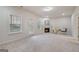 Cozy living room with fireplace, ample natural light and neutral carpeting at 10775 Brunson Dr, Johns Creek, GA 30097