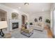 Bright living room with fireplace, lots of natural light, and comfortable furniture at 10775 Brunson Dr, Johns Creek, GA 30097