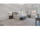 Spacious main bedroom featuring tray ceiling, neutral decor and comfortable seating area at 10775 Brunson Dr, Johns Creek, GA 30097