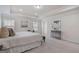 Bright main bedroom featuring neutral color palette and comfortable seating area near windows at 10775 Brunson Dr, Johns Creek, GA 30097
