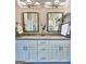 Bright bathroom featuring a double sink vanity, wall mirror, glass enclosed shower, and neutral paint at 4107 Township Pkwy # 69, Sandy Springs, GA 30342
