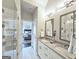 Bathroom featuring a double sink vanity, wall mirror, glass enclosed shower, and open access to bedroom at 4107 Township Pkwy # 69, Sandy Springs, GA 30342