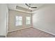 Bright bedroom with a ceiling fan and a tray ceiling complemented by natural light streaming through the windows at 4107 Township Pkwy # 69, Sandy Springs, GA 30342