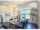 Bright dining area featuring a modern chandelier, glass table, stylish chairs, and a large window with natural light at 4107 Township Pkwy # 69, Sandy Springs, GA 30342