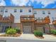 Townhome exterior with wooden balconies above each garage entry at 4107 Township Pkwy # 69, Sandy Springs, GA 30342