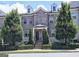 Charming three-story brick townhouse with well-manicured landscaping and a classic, symmetrical facade at 4107 Township Pkwy # 69, Sandy Springs, GA 30342