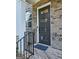 Modern black front door with horizontal window panes, brick walkway, and contemporary exterior lighting at 4107 Township Pkwy # 69, Sandy Springs, GA 30342