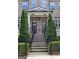 Inviting front entrance with twin address numbers, featuring a brick stairway, metal railings, and manicured greenery at 4107 Township Pkwy # 69, Sandy Springs, GA 30342