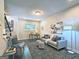 Open living room with a comfortable sofa, accent chair, and desk area, complemented by natural light at 4107 Township Pkwy # 69, Sandy Springs, GA 30342