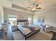 Main bedroom with large windows, neutral colors, wood flooring, and tray ceiling with ceiling fan at 4107 Township Pkwy # 69, Sandy Springs, GA 30342