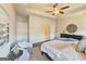 A calm main bedroom with neutral decor, a tray ceiling with fan, and dark wood floors at 4107 Township Pkwy # 69, Sandy Springs, GA 30342