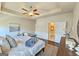 Main bedroom featuring a bed, tray ceiling with fan, and wood floors at 4107 Township Pkwy # 69, Sandy Springs, GA 30342