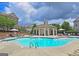 Community pool with sundeck, lounge chairs and clubhouse at 4107 Township Pkwy # 69, Sandy Springs, GA 30342