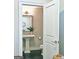 Powder room featuring a pedestal sink with a single lever faucet, a stylish mirror, and modern lighting at 4107 Township Pkwy # 69, Sandy Springs, GA 30342