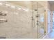 Glass enclosed shower featuring marble tiling, a shower head, and a built-in shelf at 4107 Township Pkwy # 69, Sandy Springs, GA 30342