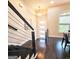 Elegant staircase featuring modern railings, dark wood floors, and a bright, inviting landing with a view at 4107 Township Pkwy # 69, Sandy Springs, GA 30342