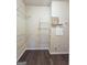 Walk-in closet featuring dark wood floors, wire shelving, and access to electric at 4107 Township Pkwy # 69, Sandy Springs, GA 30342