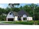 Beautiful white brick home with a cozy entrance and well-maintained lawn in a serene, tree-filled setting at 1077 Crooked Creek Rd, Lithonia, GA 30058