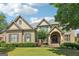 Charming two-story brick home with a manicured lawn and a grand, arched entryway, offering curb appeal at 2452 Stone Manor Ne Dr, Buford, GA 30519