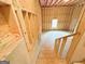 Stairs leading to a unfinished basement featuring exposed framing and insulation at 5342 Legacy Trl # 30, Douglasville, GA 30135
