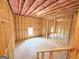 Unfinished basement with wood frame walls, ceiling insulation, and bright natural light from two windows at 5342 Legacy Trl # 30, Douglasville, GA 30135