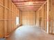 A large unfinished basement with wood framing, ceiling insulation, and natural light from a window at 5342 Legacy Trl # 30, Douglasville, GA 30135