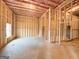 Unfinished basement featuring wood framing, ceiling insulation, a window, and clearly defined room layouts at 5342 Legacy Trl # 30, Douglasville, GA 30135