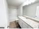 Bathroom with a large vanity, a single sink, wood flooring, and a shower-tub combo at 5342 Legacy Trl # 30, Douglasville, GA 30135