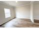 Bright and airy bedroom featuring light wood floors and a window with a view at 5342 Legacy Trl # 30, Douglasville, GA 30135
