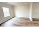 Clean and simple bedroom featuring light wood floors and a bright window at 5342 Legacy Trl # 30, Douglasville, GA 30135