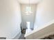High-ceiling foyer with chandelier, transom window, and view from the top of the staircase at 5342 Legacy Trl # 30, Douglasville, GA 30135