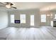 Spacious living room featuring luxury vinyl flooring, electric fireplace and access to the kitchen at 5342 Legacy Trl # 30, Douglasville, GA 30135