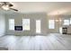 Open-concept living room with luxury vinyl flooring, electric fireplace and access to the kitchen at 5342 Legacy Trl # 30, Douglasville, GA 30135