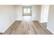 Bright and airy living room featuring light wood floors and neutral paint at 5342 Legacy Trl # 30, Douglasville, GA 30135