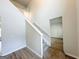 View of the light-filled staircase landing featuring modern light wood flooring and neutral tones at 5342 Legacy Trl # 30, Douglasville, GA 30135