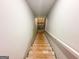 Basement stairs with a wooden frame, leading down into the unfinished basement at 5342 Legacy Trl # 30, Douglasville, GA 30135