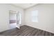 A bedroom features an open door to a patio and a window with white blinds at 7301 Cranleigh St, Covington, GA 30014