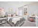 Bright bedroom with stylish decor, featuring a gray bed with upholstered headboard and coordinated furniture at 7301 Cranleigh St, Covington, GA 30014