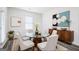 Dining room with modern round table, upholstered chairs, and artwork, creating a stylish atmosphere at 7301 Cranleigh St, Covington, GA 30014