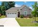 Charming single-Gathering home featuring a two-car garage, red brick accents, and a well-manicured front yard at 7301 Cranleigh St, Covington, GA 30014