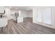 An open kitchen and living space shows granite countertops and stainless steel appliances at 7301 Cranleigh St, Covington, GA 30014