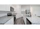 Well-lit kitchen featuring granite countertops, stainless steel appliances, and an island with a dual-bowl sink at 7301 Cranleigh St, Covington, GA 30014
