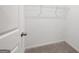 Walk-in closet with neutral carpet and a wire shelf and rod system at 7301 Cranleigh St, Covington, GA 30014