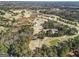 Aerial view of a golf course surrounded by trees and a pond at 4178 Castle Pines Ct, Tucker, GA 30084