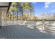 Wooden back deck featuring white railing surrounded by mature trees at 4178 Castle Pines Ct, Tucker, GA 30084