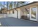 Spacious back deck of the white brick home features sliding doors leading into the living room at 4178 Castle Pines Ct, Tucker, GA 30084