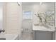 Updated bathroom features a double vanity with marble countertop and tub with white subway tile at 4178 Castle Pines Ct, Tucker, GA 30084