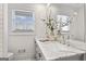 Bathroom featuring a marble countertop, double vanity and a decorative plant at 4178 Castle Pines Ct, Tucker, GA 30084
